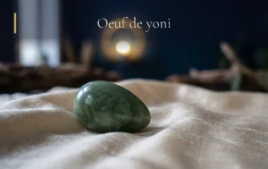 Un oeuf de yoni en pierre polie repose délicatement sur de la soie lumineuse